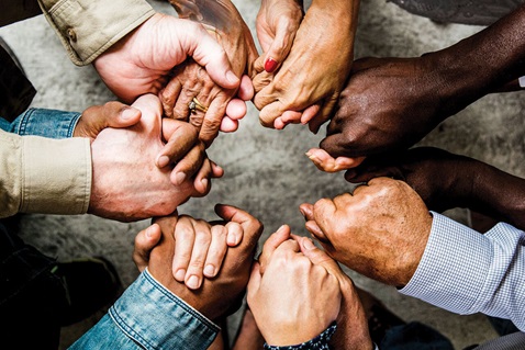 A diverse group of people stand in a circle holding hands. Image by Rawpixel, iStockphoto.com. A diverse group of people stand in a circle holding hands. Image by Rawpixel, iStockphoto.com.