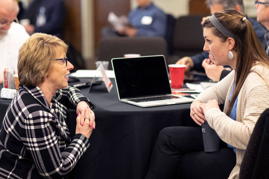 Judi Kenaston, Northeastern Jurisdiction, talks with Michelle Hettman, Southeastern Jurisdiction, during the meeting of the Connectional Table held at United Methodist Discipleship Ministries in Nashville, Tenn., April 2. Photo by Kathleen Barry, UM News