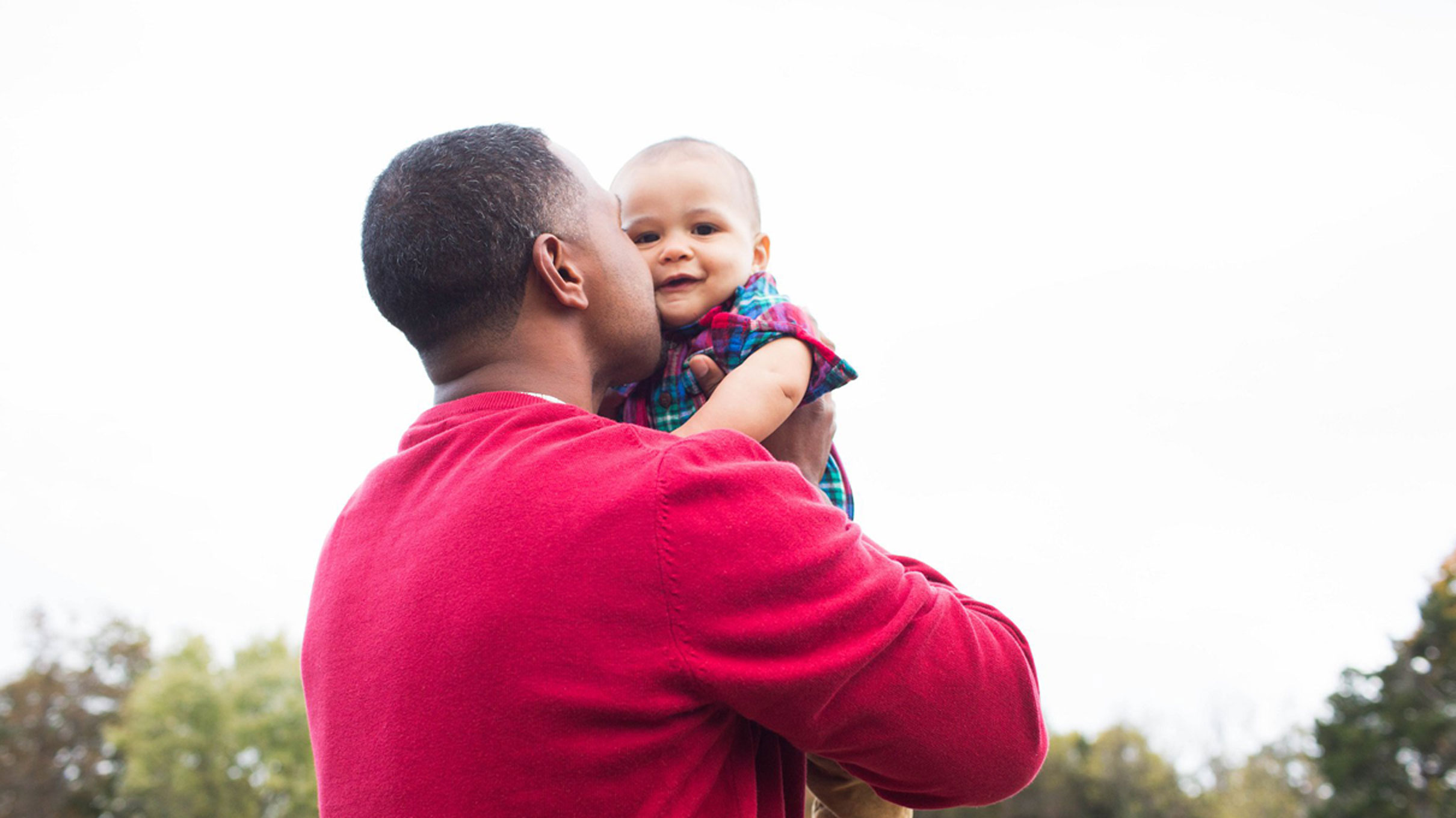 A dad kisses his baby. Photo courtesy Molly Wantland, simplymphotography.com.