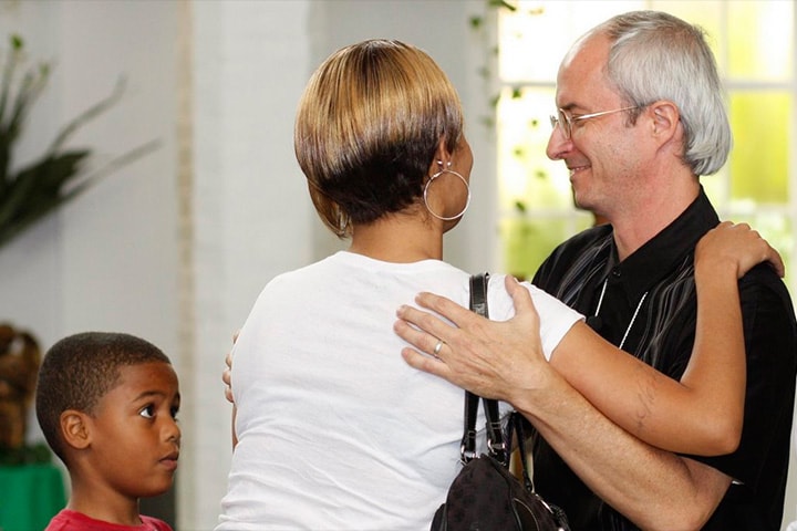 The Rev. Shawn Moses (right) of First Grace United Methodist Church, New Orleans, welcomes a new family joining the church. Photo by Kathy L. Gilbert, UM News.