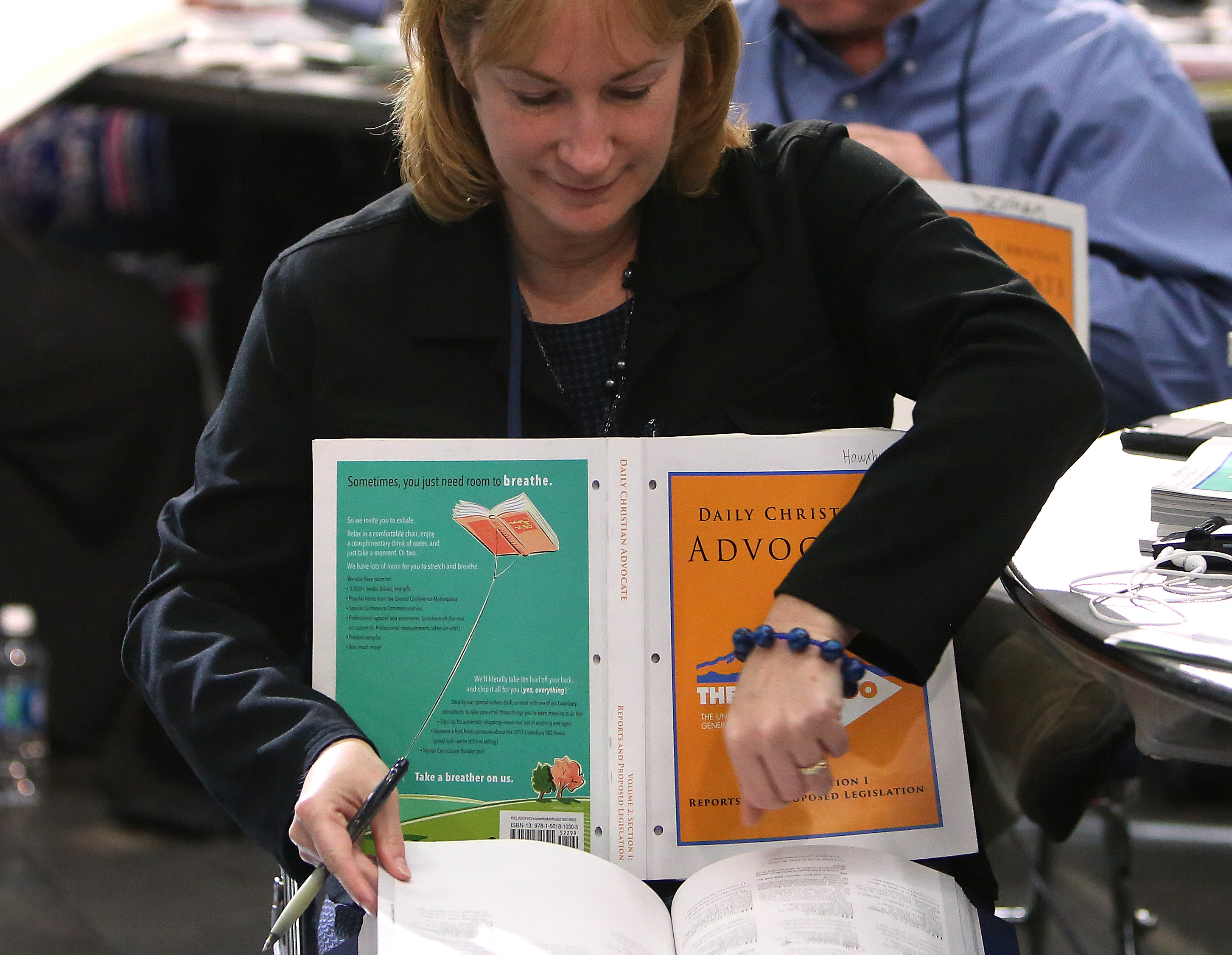 Jean Hawxhurst, delegate from the Kentucky Conference, follows the afternoon session of calendar items and petitions at the 2016 United Methodist General Conference in Portland, Ore. Photo by Kathleen Barry, UMNS.