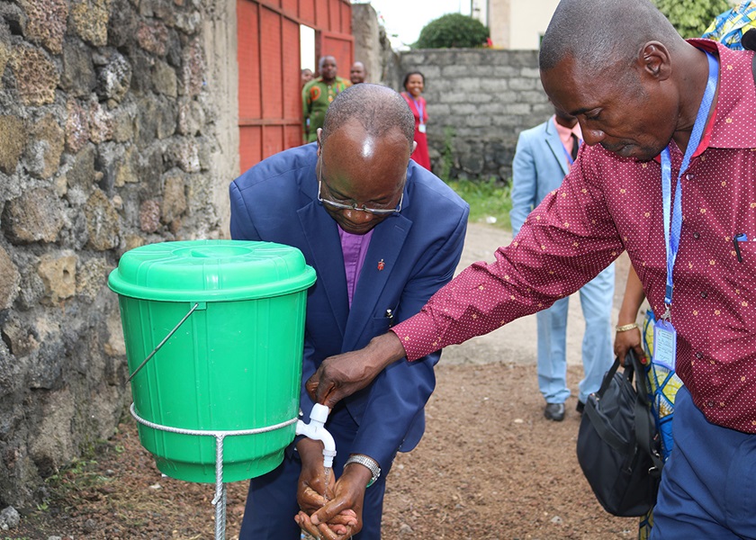 During the Ebola epidemic, East Congo Area Bishop Gabriel Yemba Unda washes his hands and is helped by the Rev. Jean-Paul Omole, superintendent of the Goma District, during the Kivu Annual Conference in June 2019. Photo By Chadrack Londe, UM News.
