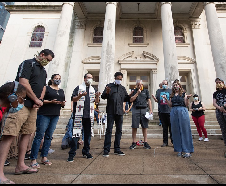 Clergy members gather in prayer during a vigil at McKendree United Methodist Church in Nashville, Tenn., to grieve and remember people lost to acts of racism. Photo by Mike DuBose, UM News. Clergy members gather in prayer during a vigil at McKendree United Methodist Church in Nashville, Tenn., to grieve and remember people lost to acts of racism. Photo by Mike DuBose, UM News.