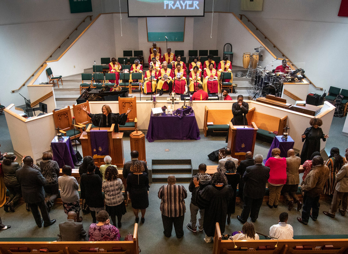 The Rev. Sheila Peters from Braden Memorial United Methodist Church preaches March 7, 2020, at a joint Sunday service held at Gordon Memorial United Methodist Church in Nashville, Tenn. Praying over attendees on the floor is the Rev. Paula B. Smith, pastor at Gordon Memorial. Strengthening The Black Church for the 21st Century works with predominately Black churches like Braden and Gordon on effective mission and ministry. Photo by Kathleen Barry, UM News.