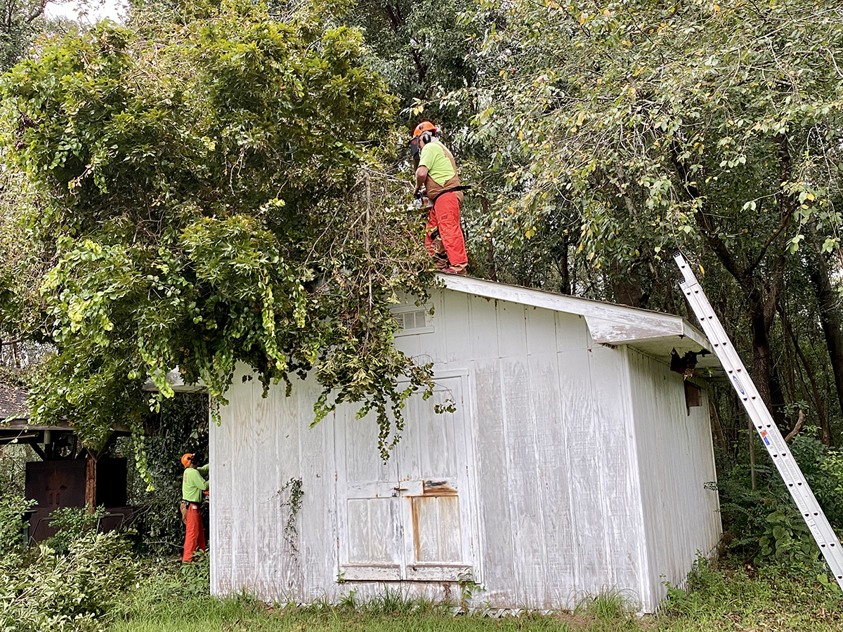 An early response team from South Carolina responds to relief/recovery work at South Brookley United Methodist Church in Mobile, Alabama, after the destructive path of Hurricane Sally. On the roof is the Rev. John Elmore, pastor of St. Mark United Methodist Church, Greenwood, South Carolina. On the ground is Phil Griswold, member of New Beginnings United Methodist Church, Boiling Springs, South Carolina. Photo by Jill Evans.
