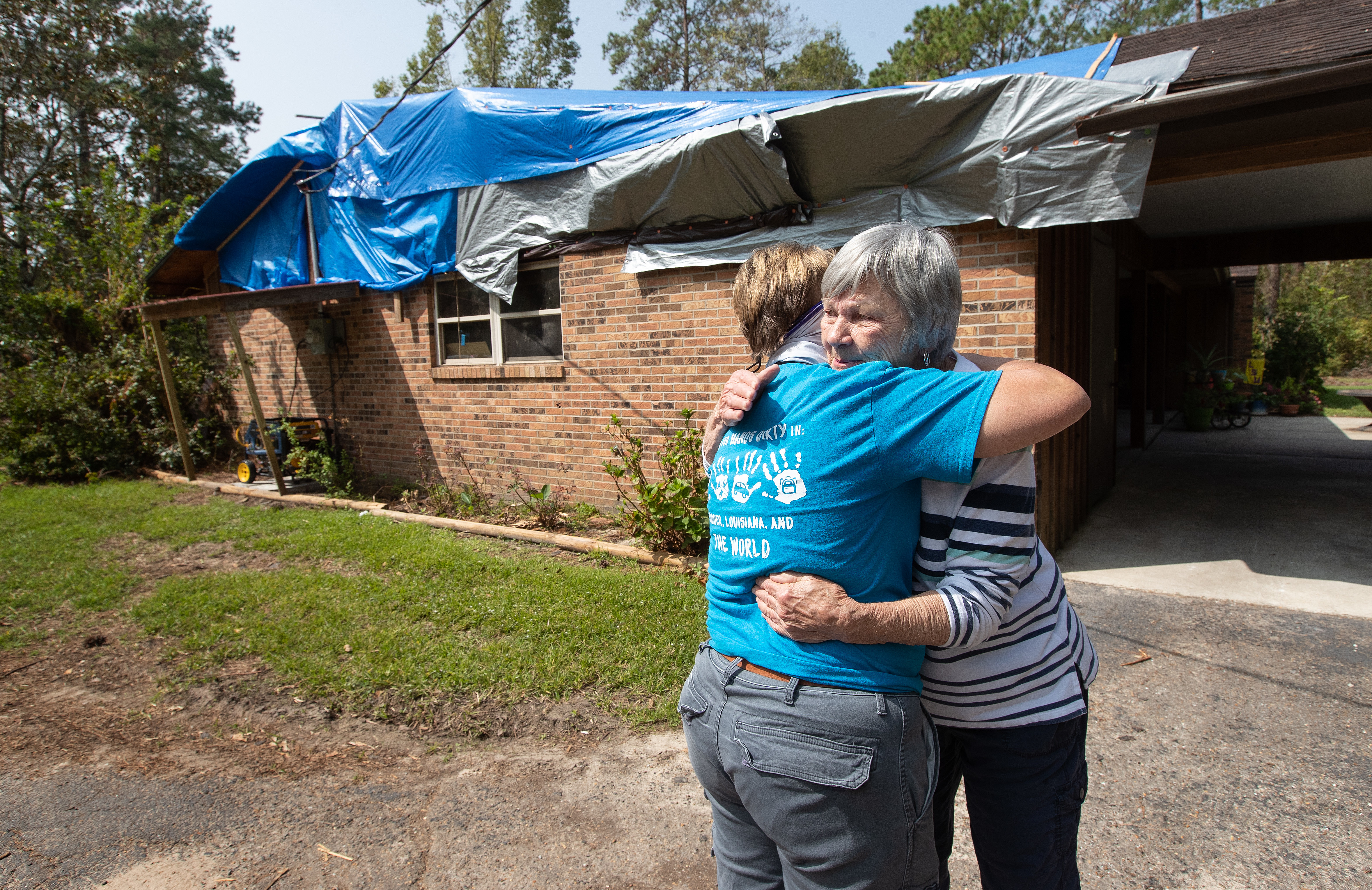 Mary Alice Wisdom (right) hugs her pastor, the Rev. Laraine Waughtal during a visit to Wisdom’s home in DeRidder, La., following Hurricane Laura. The hurricane damaged her roof and knocked out electricity. Photo by Mike DuBose, UM News.
