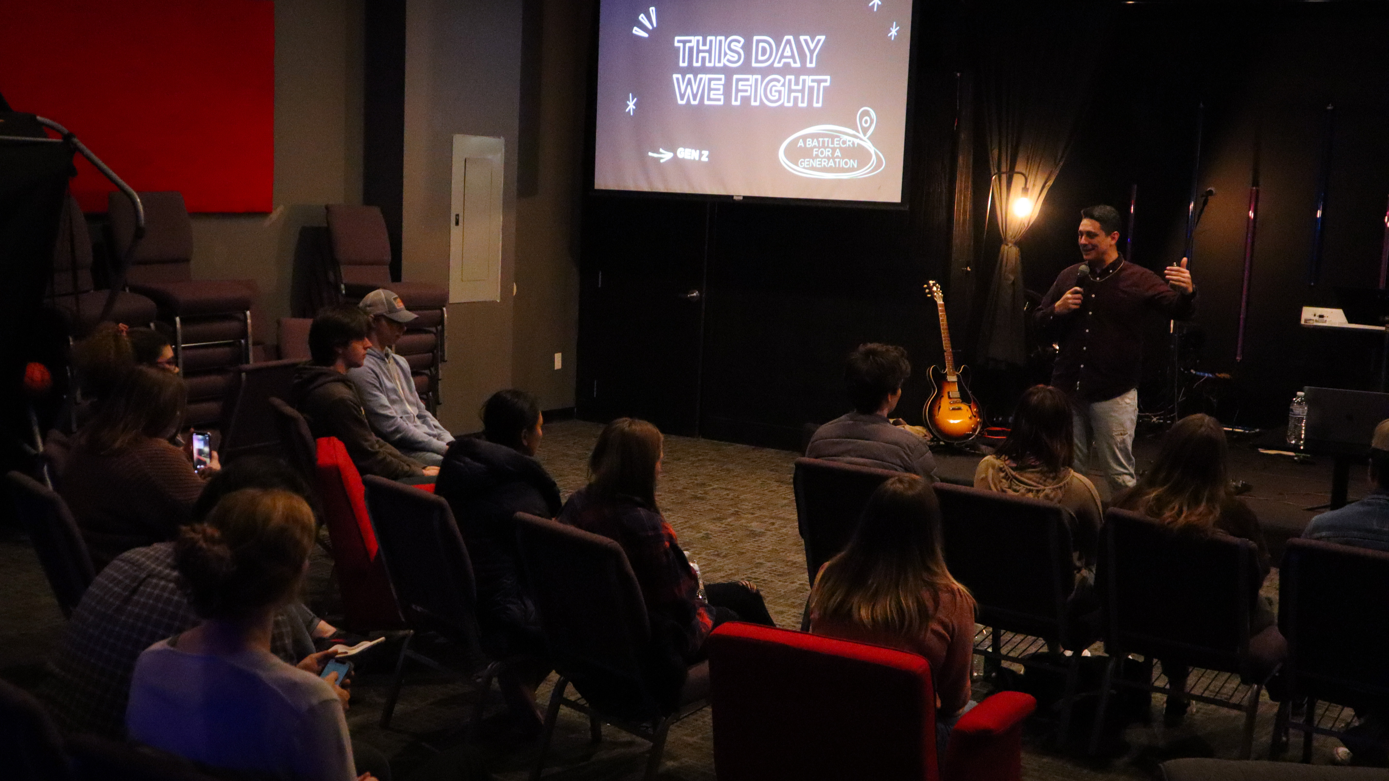 Group of young people listen to a message during a night of worship. Photo by Aileen Jimenez, UMCOM.