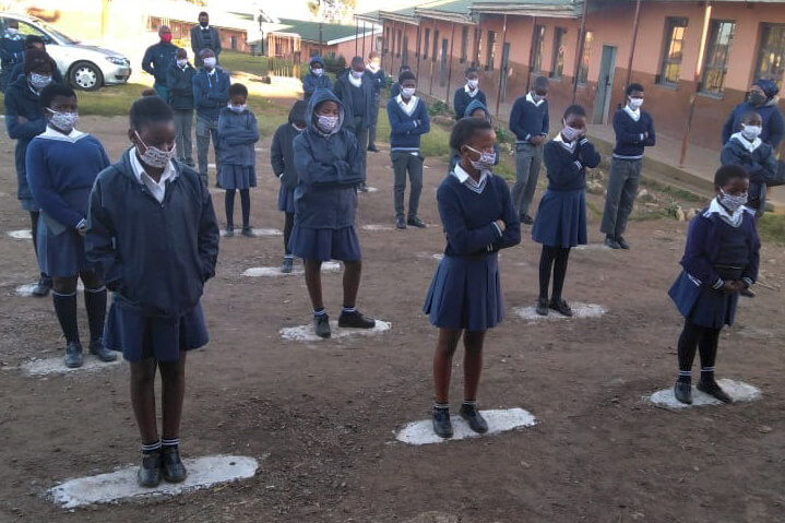 Students wear face masks and observe social distancing as they receive their daily orientation prior to starting classes at Port Edward Primary School in Durban, South Africa. Photo by Nandipha Mkwalo, UM News.
