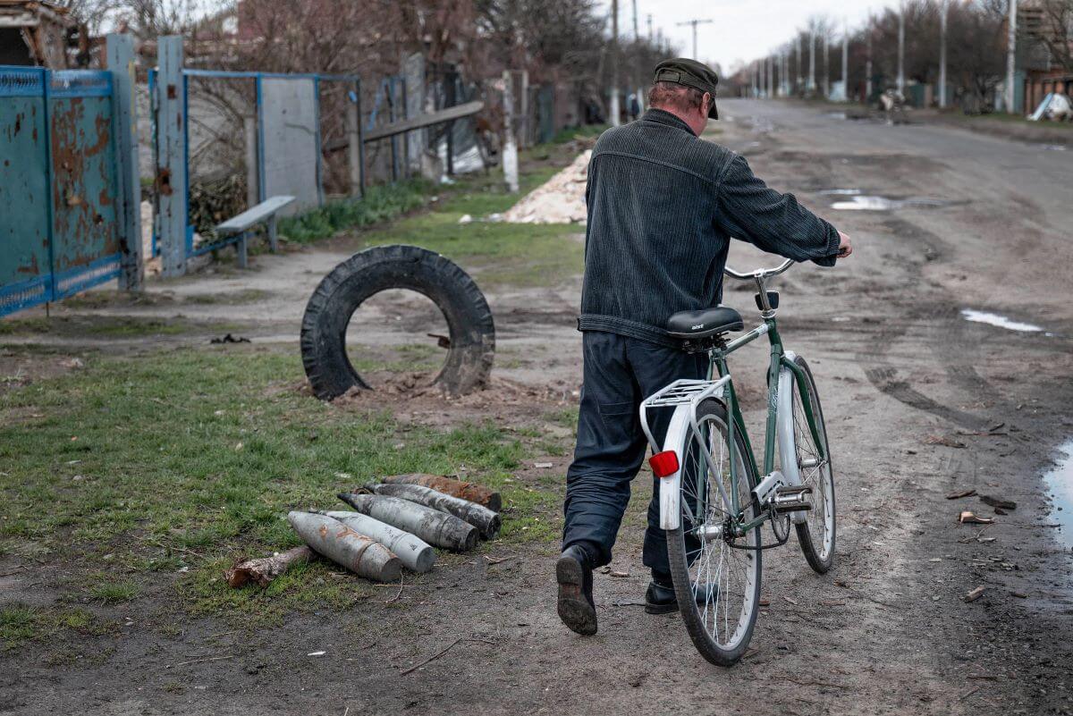 The village of Andriivka was occupied by Russian forces for 35 days. The main road linking Bodoroyanka to Markeridge runs through it, and a man on a bike passes by active warheads out in the open. (Photo: Sean Sutton, MAG.)