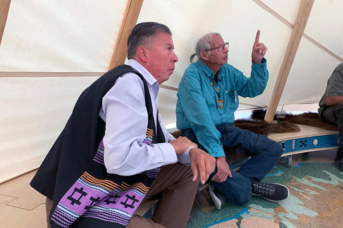 Great Plains Conference Bishop David Wilson, left, and Eugene Ridgely Jr., a Sand Creek representative of the Northern Arapaho tribe, gather in an Arapaho tipi located at the History Colorado Center in Denver. Both men are part of the United Methodist Responses to the Sand Creek Massacre Team, which met Sept. 20-21 at Iliff School of Theology to formulate next steps in the denomination’s work to atone for its role in the 1864 Sand Creek Massacre. Photo by Joey Butler, UM News.