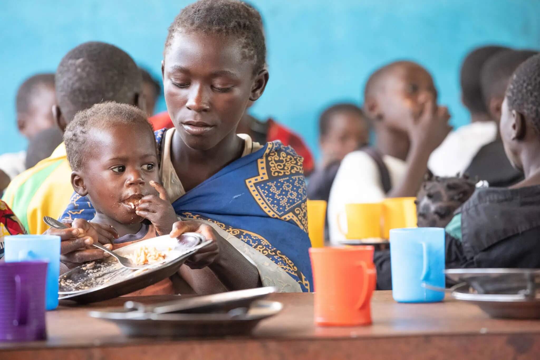 Pure satisfaction at the Sunday school children's meal, Quessua mission. Much of the produce for the meal is grown by the Quessua Agricultural Center. (Photo: Mike DuBose, UM News)