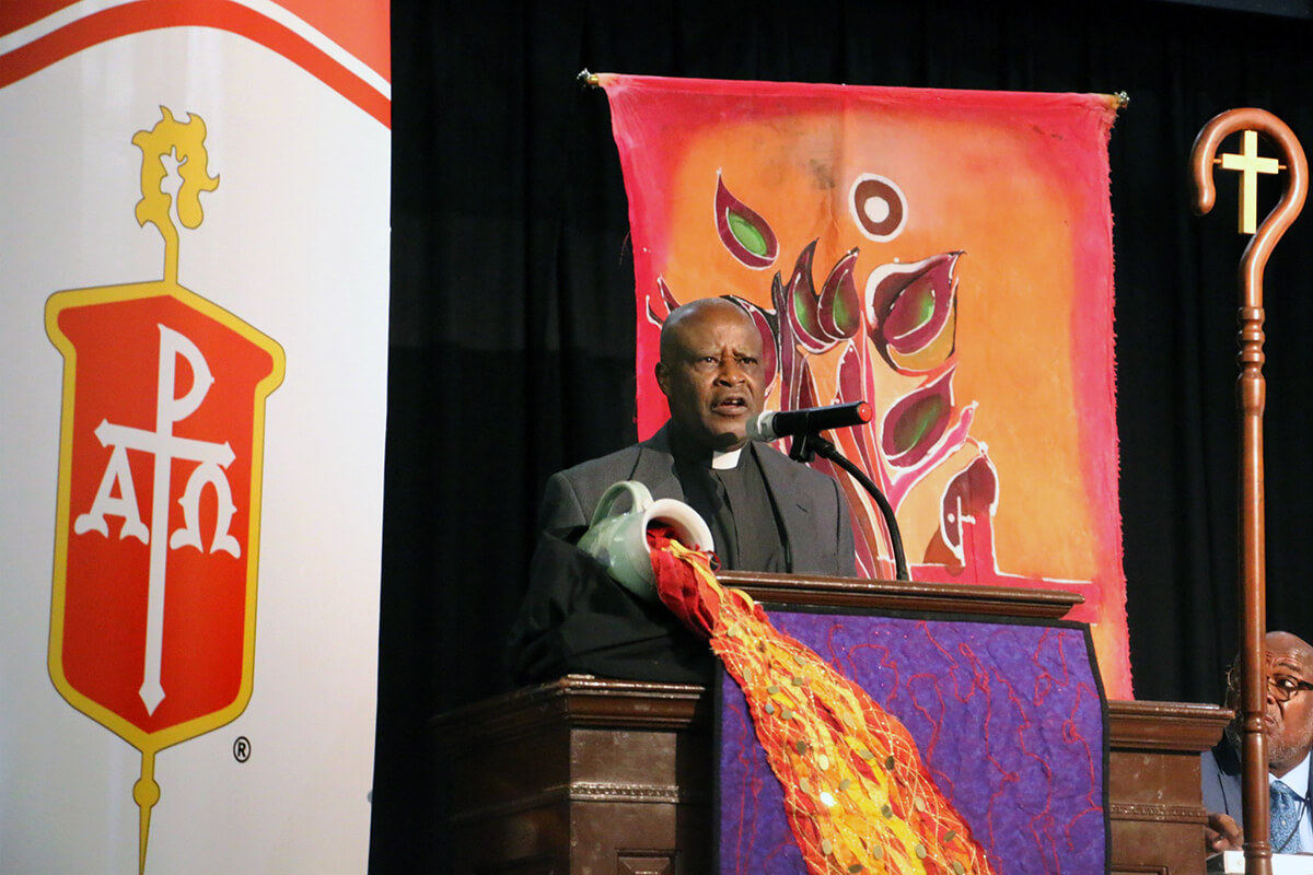 Father Emmanuel Katongole, a Catholic priest and theologian who previously worked at Duke Divinity School, addresses the United Methodist Council of Bishops, meeting this week at Epworth by the Sea Conference Center in St. Simons Island, Ga. At the invitation of the bishops’ Anti-Racism Leadership Team, Katongole spoke of the challenges racism and tribalism present to Christians. Photo by Rick Wolcott, Council of Bishops.