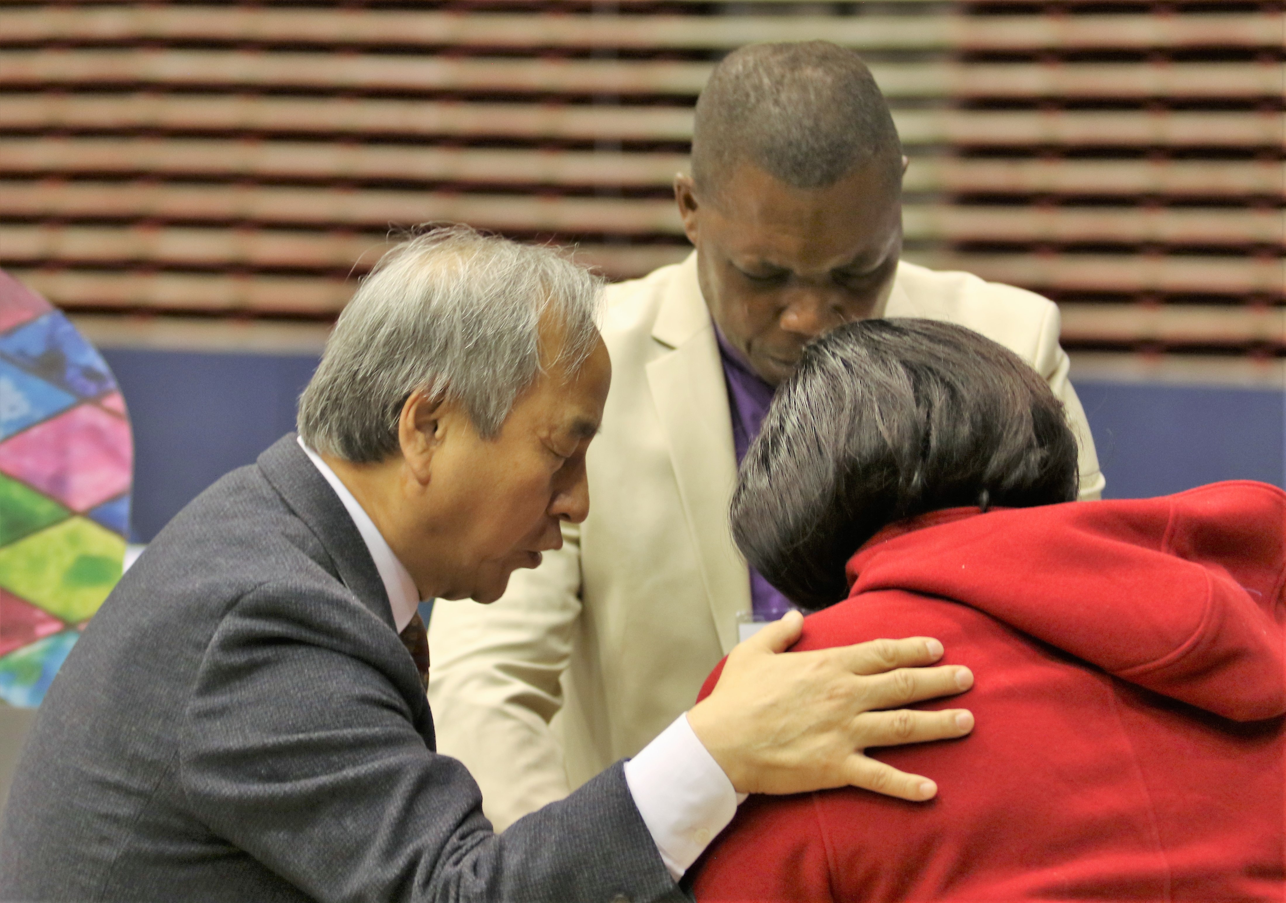 Bishop Hee-soo Jung prays for a delegate during a Holy Communion service held on Feb. 23, 2019 in St. Louis. Photo by Thomas Kim, UMNS.